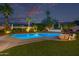Inviting backyard pool surrounded by palm trees, lush landscaping, and a sunbathing area at 7821 N Via De La Sombre --, Scottsdale, AZ 85258