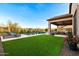 This is a spacious backyard with a pool, outdoor kitchen, covered patio, and lounge chairs at 8633 E Kael Cir, Mesa, AZ 85207