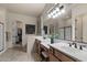 Elegant bathroom with double vanity sinks, and a glass-enclosed shower at 8633 E Kael Cir, Mesa, AZ 85207