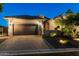 Charming home exterior with a well-manicured lawn, and a spacious driveway leading to a two-car garage at 8633 E Kael Cir, Mesa, AZ 85207