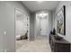 Inviting hallway with arched doorways, neutral paint, tile floors and tasteful decor at 8633 E Kael Cir, Mesa, AZ 85207