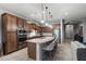 Gourmet kitchen featuring granite countertops, stainless steel appliances, and a large island with bar seating at 8633 E Kael Cir, Mesa, AZ 85207