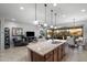 Open-concept kitchen with island seamlessly connects to the living and dining areas, perfect for modern living at 8633 E Kael Cir, Mesa, AZ 85207