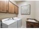 Laundry room equipped with washer, dryer, sink, storage cabinets, and countertop space at 8633 E Kael Cir, Mesa, AZ 85207