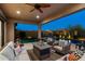 Inviting outdoor patio with comfortable seating, fan, overlooking the pool, perfect for entertaining at 8633 E Kael Cir, Mesa, AZ 85207