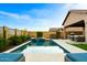 Beautiful backyard pool with a spa and built in seating near the outdoor kitchen area at 8633 E Kael Cir, Mesa, AZ 85207