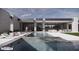 Modern home's backyard with a swimming pool, patio, and desert landscaping for relaxation at 9002 E Havasupai Dr, Scottsdale, AZ 85255
