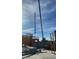 Construction featuring a crane lifting steel beams set against a bright blue sky with some cloud cover at 9002 E Havasupai Dr, Scottsdale, AZ 85255