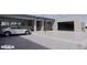 Modern exterior showcasing a car and gray-toned home with three-car garage and unique architectural design at 9002 E Havasupai Dr, Scottsdale, AZ 85255