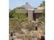 Striking modern home exterior set against a backdrop of iconic desert landscaping and mountain views at 9002 E Havasupai Dr, Scottsdale, AZ 85255