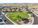 Scenic aerial view of a well-maintained community park surrounded by homes and desert landscape at 948 E Wiley Way, Casa Grande, AZ 85122