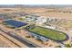 High aerial view of a comprehensive school complex featuring sports facilities and solar panels at 948 E Wiley Way, Casa Grande, AZ 85122