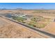Wide aerial view of school facilities, sports fields, and a solar panel array in a community at 948 E Wiley Way, Casa Grande, AZ 85122