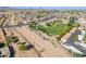 Aerial view of a neighborhood park near desert landscape, homes, and covered parking at 948 E Wiley Way, Casa Grande, AZ 85122
