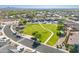 A lush green community park surrounded by lovely homes in a quiet suburban neighborhood at 948 E Wiley Way, Casa Grande, AZ 85122