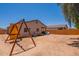 View of the backyard with a play structure and shade tree; perfect for Gathering fun and relaxation at 948 E Wiley Way, Casa Grande, AZ 85122