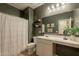 Neutral bathroom with shower/tub combination, floating shelves, and light countertops at 948 E Wiley Way, Casa Grande, AZ 85122