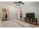 Bright bedroom with a ceiling fan, television and access to an ensuite bathroom at 948 E Wiley Way, Casa Grande, AZ 85122