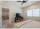 Bedroom with flat screen television, ceiling fan and view into the living room at 948 E Wiley Way, Casa Grande, AZ 85122
