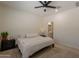 Comfortable bedroom with neutral tones, ensuite bathroom and ceiling fan at 948 E Wiley Way, Casa Grande, AZ 85122