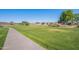 View of a park with a concrete walking trail surrounded by single-Gathering homes and desert landscaping at 948 E Wiley Way, Casa Grande, AZ 85122