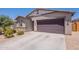 Charming single-story home featuring a two-car garage, desert landscaping, and neutral earth tone colors at 948 E Wiley Way, Casa Grande, AZ 85122
