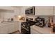 Modern kitchen showcasing white cabinets, stainless steel appliances, and quartz countertops at 948 E Wiley Way, Casa Grande, AZ 85122