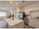 Open kitchen featuring an island and stainless steel appliances with an open view to the living area at 948 E Wiley Way, Casa Grande, AZ 85122
