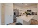 Bright kitchen features stainless steel appliances and a quartz countertop island at 948 E Wiley Way, Casa Grande, AZ 85122
