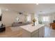 Bright and open living area with white walls, tile floors, and view of kitchen at 948 E Wiley Way, Casa Grande, AZ 85122