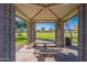 Interior view of a shade structure with a picnic table looking out onto the community park at 948 E Wiley Way, Casa Grande, AZ 85122