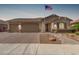 Beautiful home with a three car garage, a brick driveway and a manicured, desert landscaped yard at 1036 W Siebold Tree Ave, Queen Creek, AZ 85140