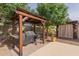 Covered grill area featuring a built-in grill, convenient prep space, and a cozy seating area nearby at 1036 W Siebold Tree Ave, Queen Creek, AZ 85140