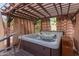 Inviting hot tub under a shaded pergola, perfect for relaxation and privacy at 1036 W Siebold Tree Ave, Queen Creek, AZ 85140