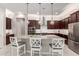 Bright kitchen with a large island, modern pendant lighting, and stainless steel appliances at 1036 W Siebold Tree Ave, Queen Creek, AZ 85140