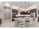 Kitchen with granite counters, stainless appliances, recessed lights, and seating at the island at 1036 W Siebold Tree Ave, Queen Creek, AZ 85140