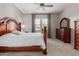 Bedroom features a decorative headboard, a ceiling fan, and a dresser at 1036 W Siebold Tree Ave, Queen Creek, AZ 85140