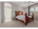 Bedroom features a decorative headboard, a ceiling fan, and an ensuite bathroom at 1036 W Siebold Tree Ave, Queen Creek, AZ 85140