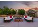 Spacious backyard with a cozy seating area around a brick fire pit, perfect for relaxation at 11737 N 143Rd Dr, Surprise, AZ 85379