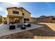 This backyard features a patio, outdoor seating, fire pit, and solar panels on detached garage at 11737 N 143Rd Dr, Surprise, AZ 85379