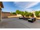 Spacious backyard patio features outdoor seating, a fire pit, and mature landscaping for relaxing and entertaining at 11737 N 143Rd Dr, Surprise, AZ 85379