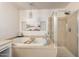 Relaxing bathroom featuring a large soaking tub, separate shower, and neutral color palette at 11737 N 143Rd Dr, Surprise, AZ 85379