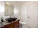 Elegant powder room with a decorative sink and a stylish mirror at 11737 N 143Rd Dr, Surprise, AZ 85379