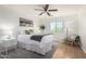 Comfortable bedroom with a ceiling fan, natural light, and neutral decor at 11737 N 143Rd Dr, Surprise, AZ 85379