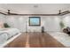 Spacious bedroom featuring hardwood floors, modern lighting, and large windows at 11737 N 143Rd Dr, Surprise, AZ 85379