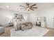 Inviting bedroom with a ceiling fan, neutral decor, and a comfortable seating area at 11737 N 143Rd Dr, Surprise, AZ 85379