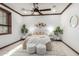 Spacious primary bedroom featuring wood trim, ceiling fan, and ample natural light at 11737 N 143Rd Dr, Surprise, AZ 85379