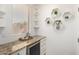 Charming coffee bar with granite counters, built-in wine cooler, hexagon decor, and shelving at 11737 N 143Rd Dr, Surprise, AZ 85379