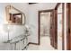 Hallway with decorative lighting, wood trim, glass table, and access to the bedroom and bathroom at 11737 N 143Rd Dr, Surprise, AZ 85379