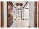Grand hallway with coffered ceilings, designer lighting, and tile flooring at 11737 N 143Rd Dr, Surprise, AZ 85379